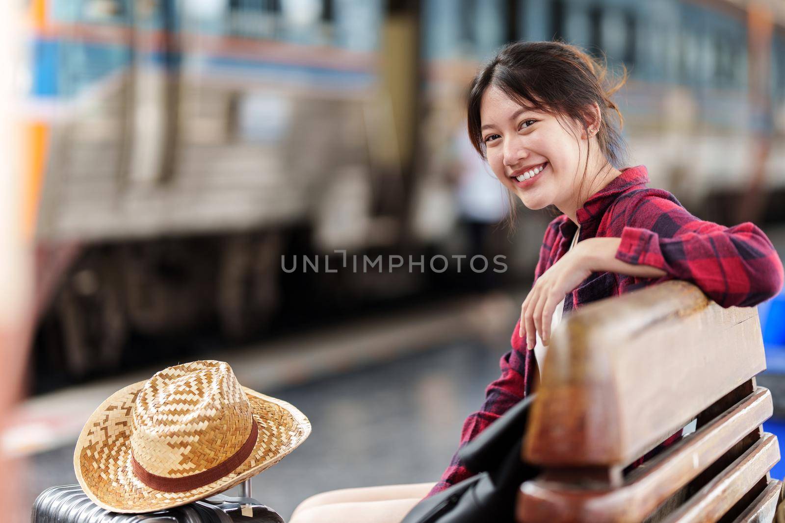 Beautiful traveler with backpack go to summer trip by train. Travel concept