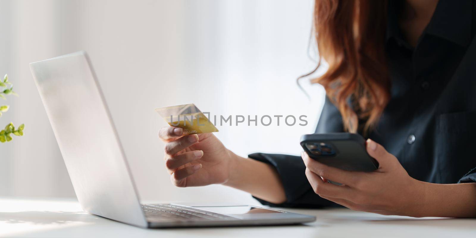 Woman using online payment and holding credit card. Online Shopping concept