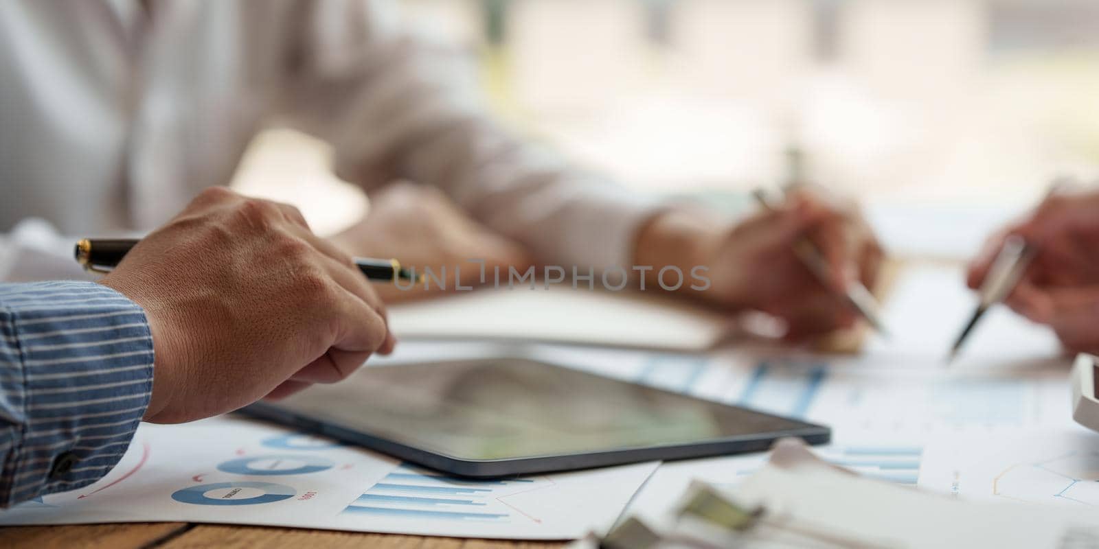 Business team hands at working with financial plan, meeting, discussion, brainstrom with tablet on office desk, Meeting concept. by itchaznong