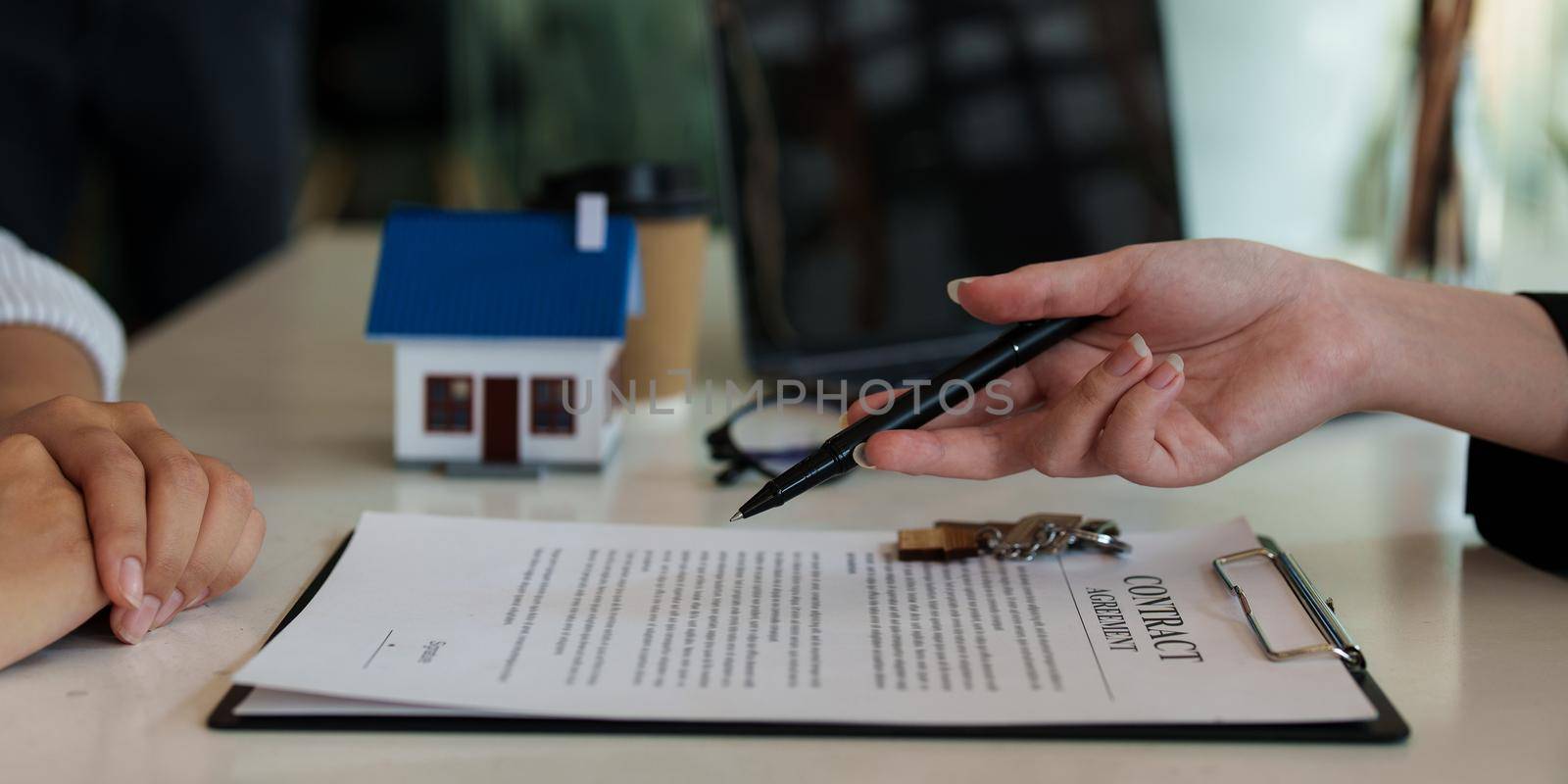 Close up Business woman or Real Estate agent explain signing agreement for buying house. Bank manager and real estate concept