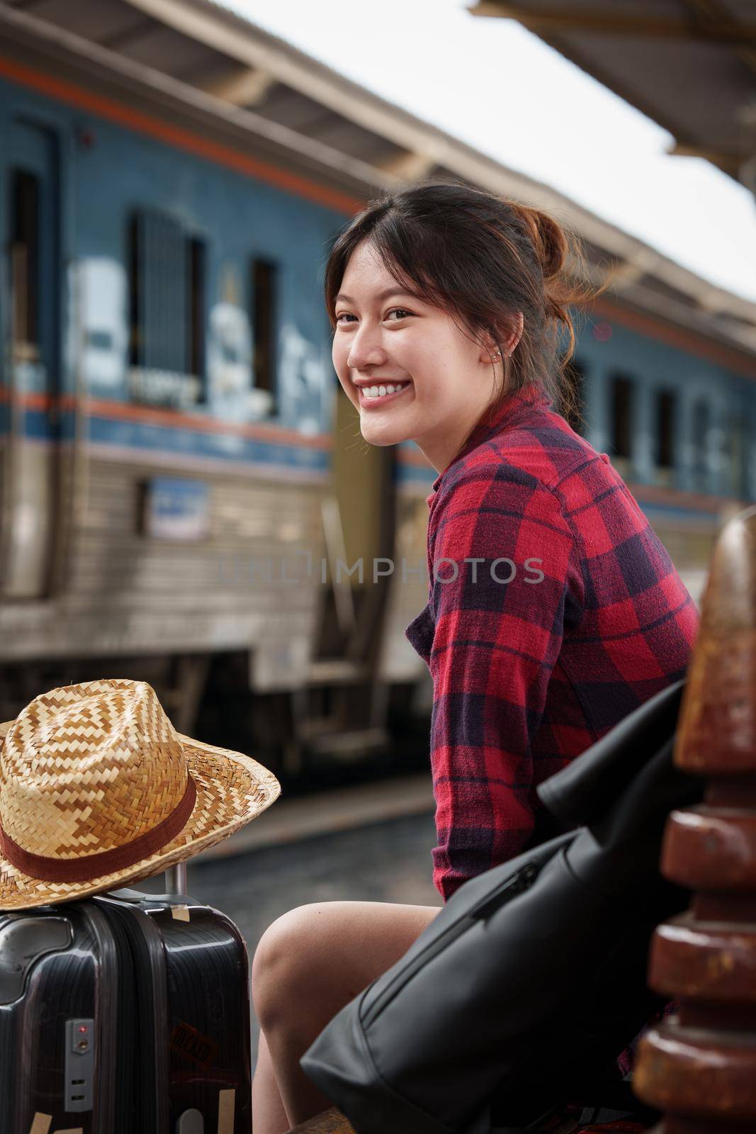 Beautiful traveler with backpack go to summer trip by train. Travel concept. by itchaznong