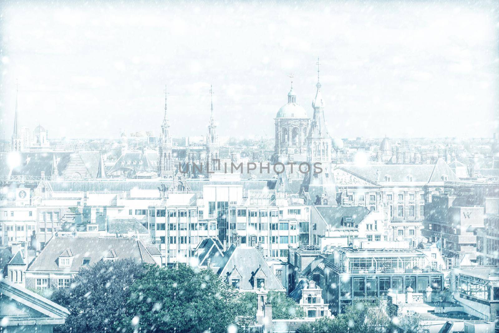 View of Amsterdam with a cloudy sky and snow, Netherlands