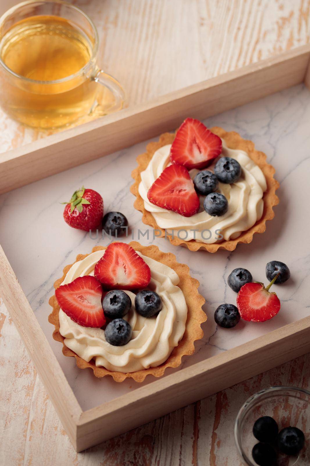 Mini tart with cream cheese and berries top view