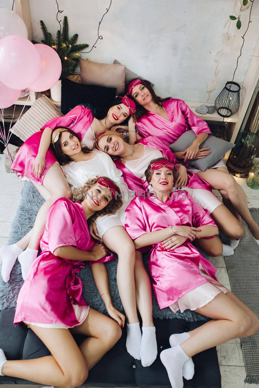 Funny girlfriends in pink robes with bride-to-be. by StudioLucky