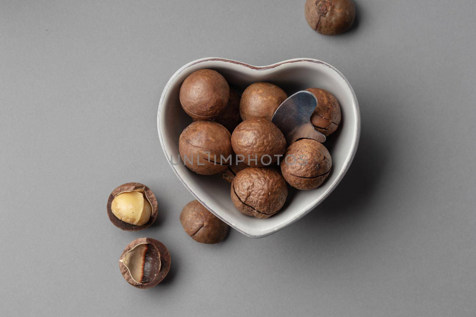 Macadamia nuts on a grey background top view