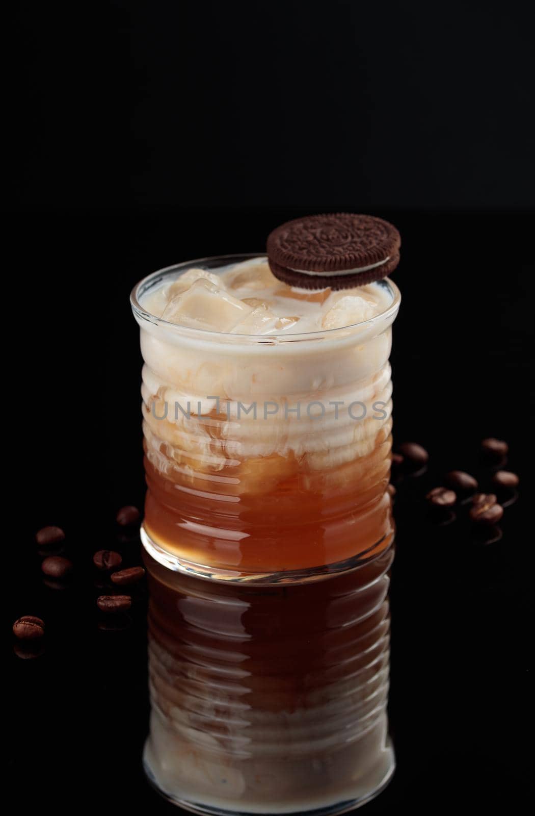 Cocktail in a glass on a black background vertical