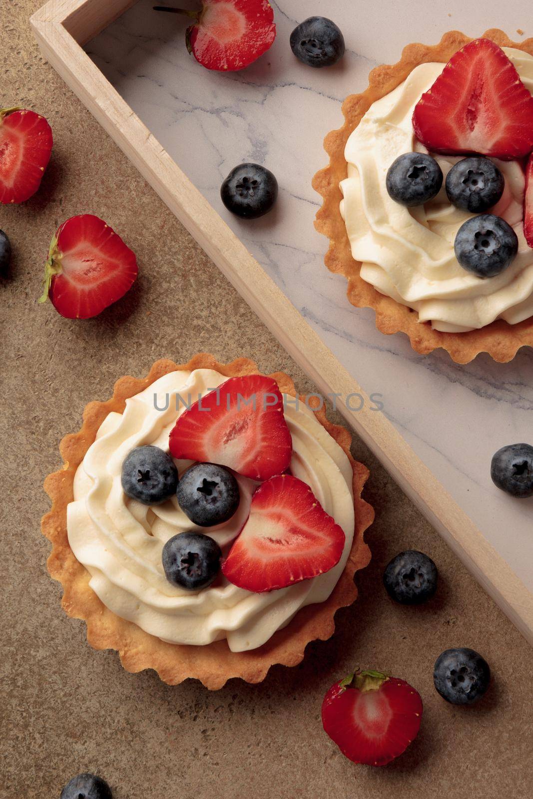 Mini tart with cream cheese and berries top view