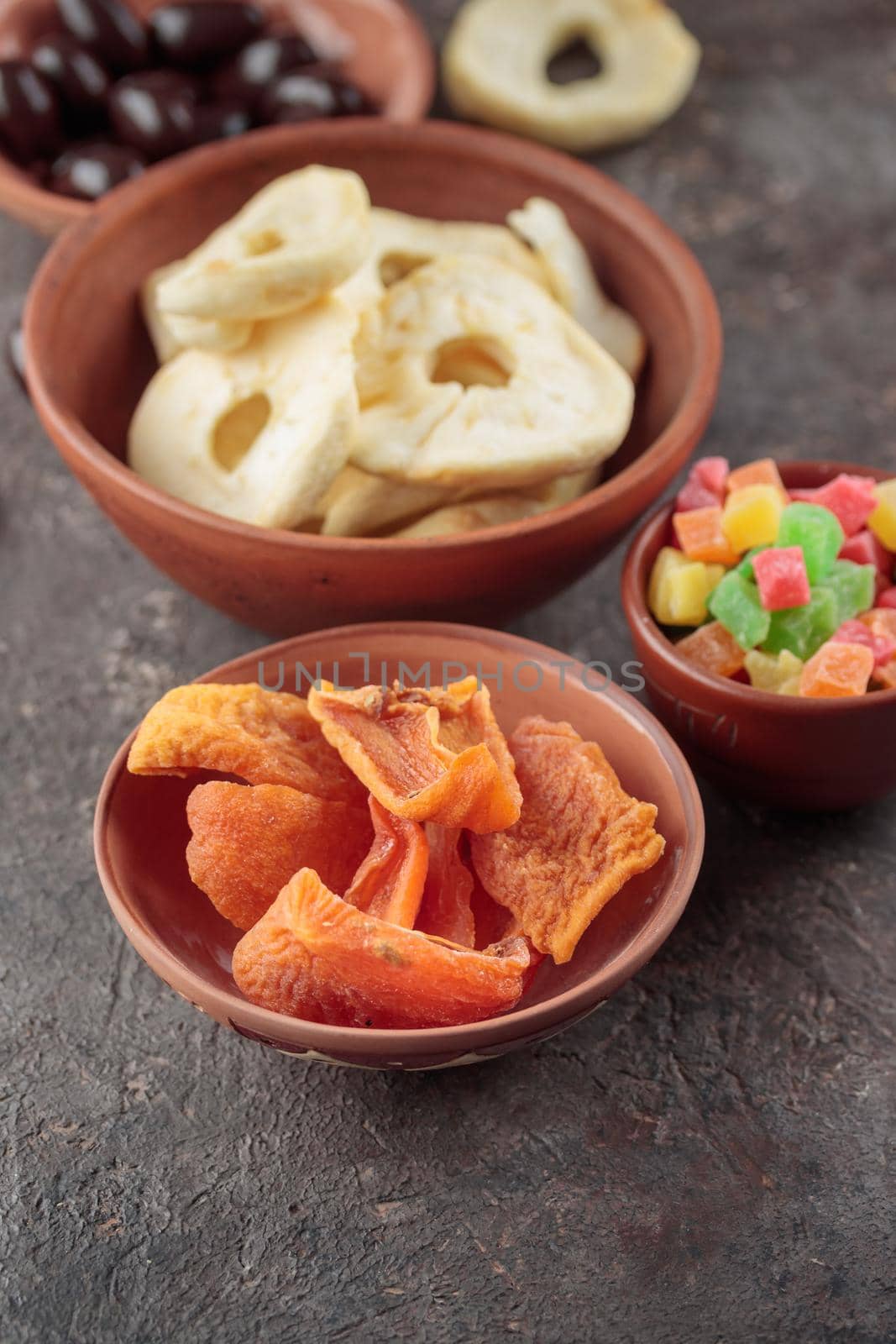 Dried Sweet Fruits on a dark brown background