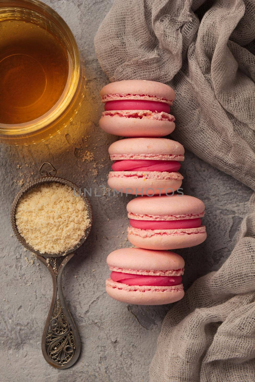 Colorful pink macaroons on a gray table