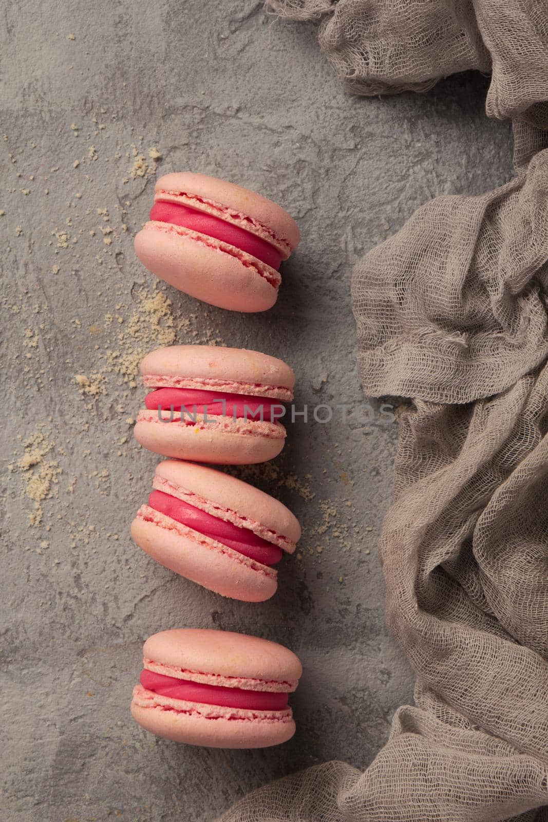 Colorful pink macaroons on a gray table