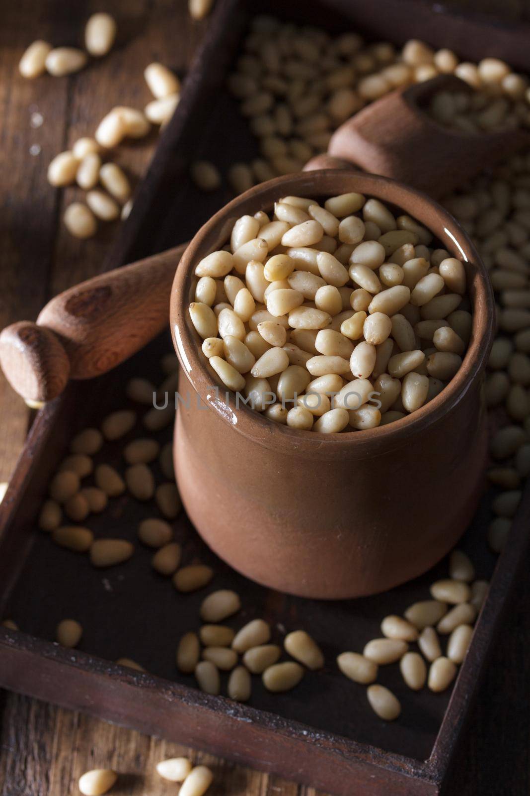 Pine nuts organic on a wooden background in a dark mood