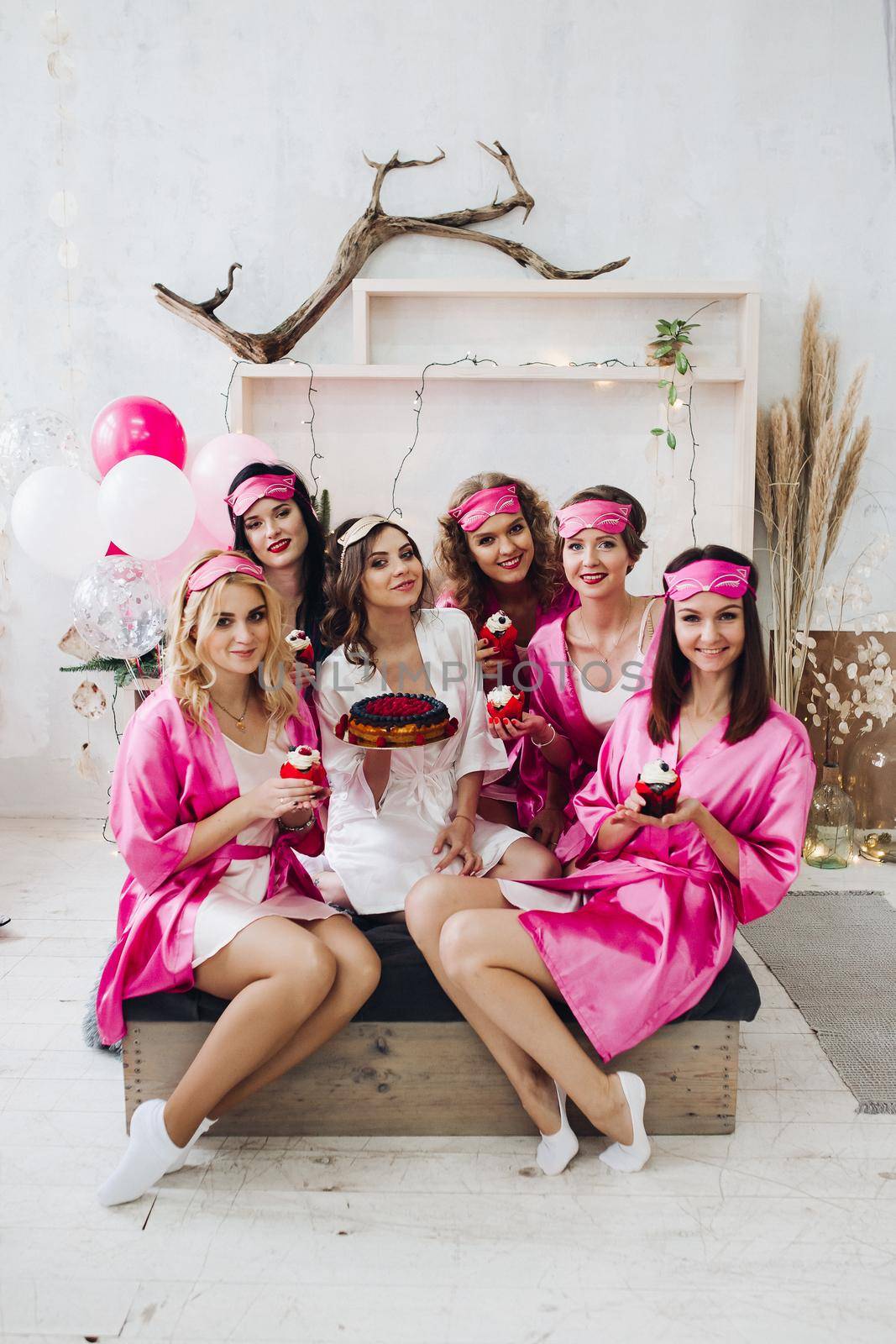 Bridesmaids with cupcakes and bride-to-be with cake. by StudioLucky