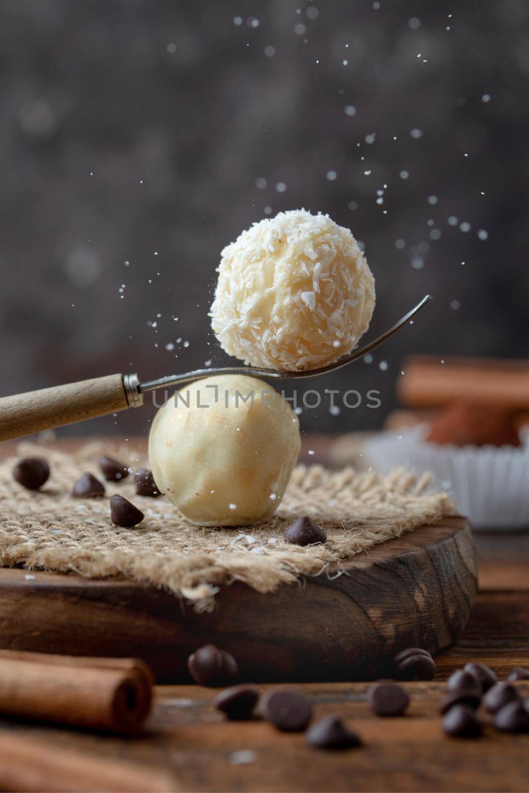Round candies with chocolate on a dark background