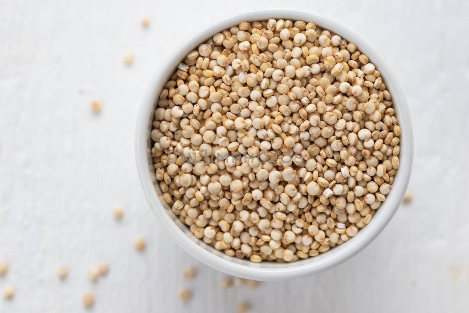 quinoa seeds in a white bowl top view macro