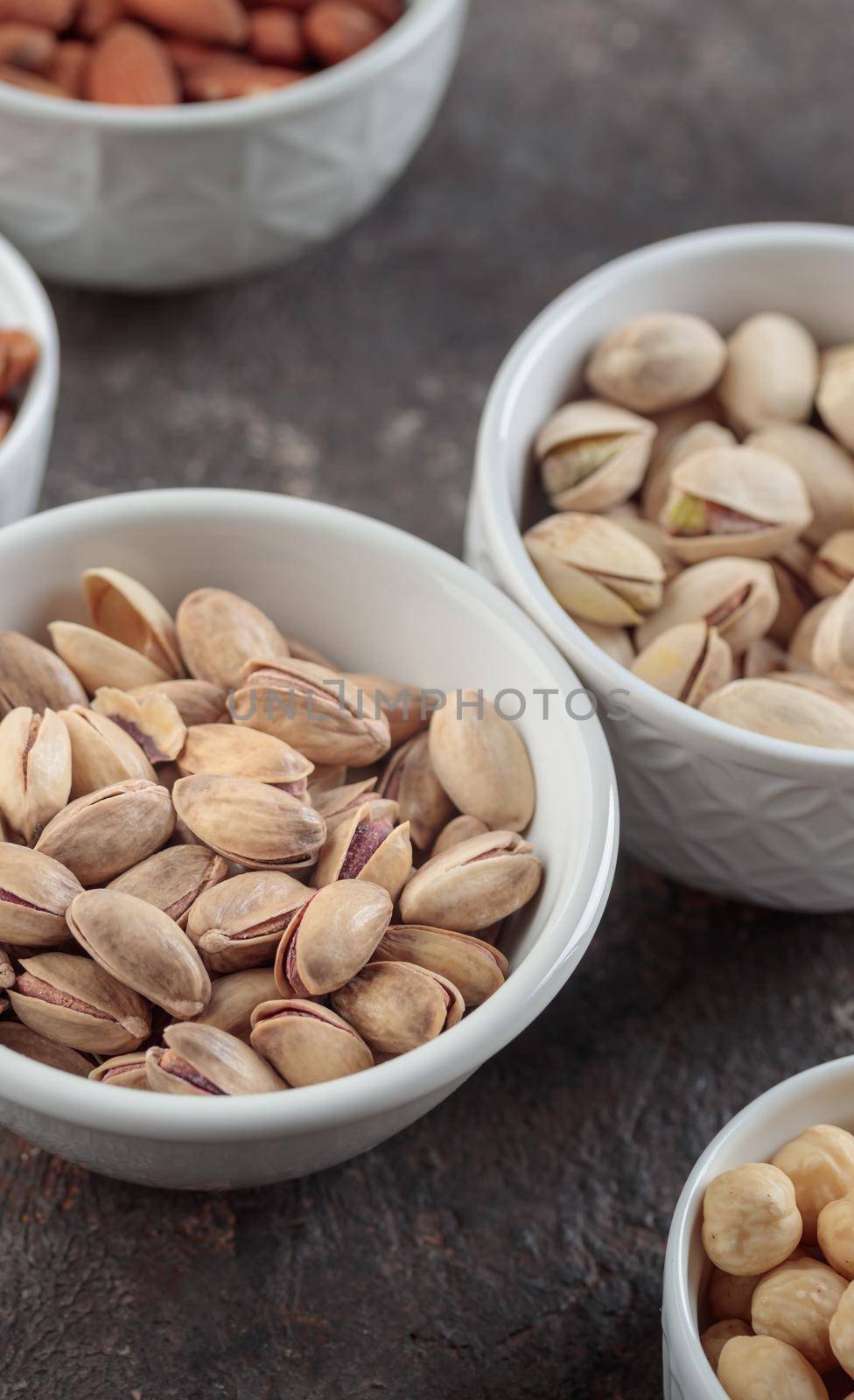 Organic pistachios on a dark background macro