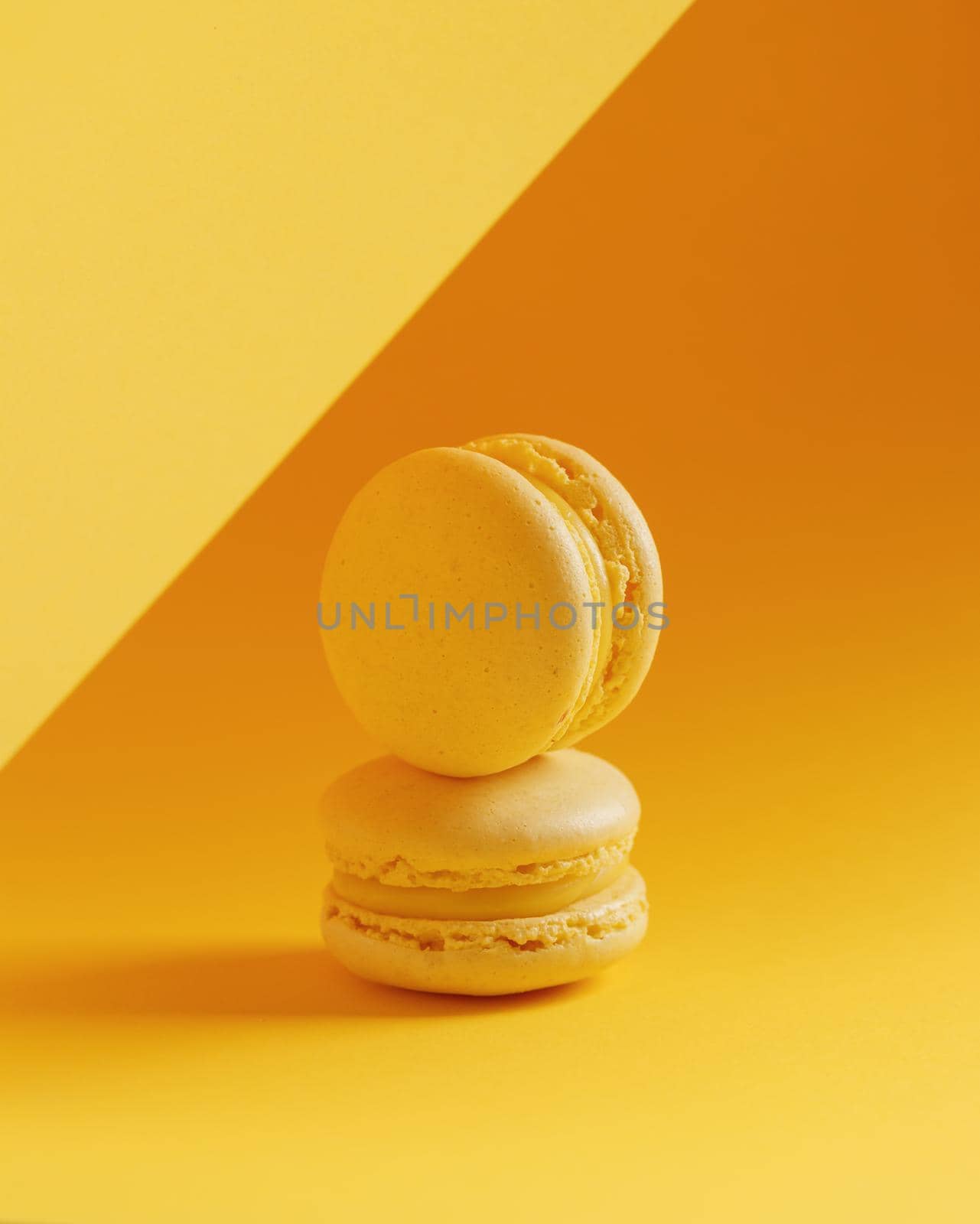 Lemon macaroons on a yellow background vertical