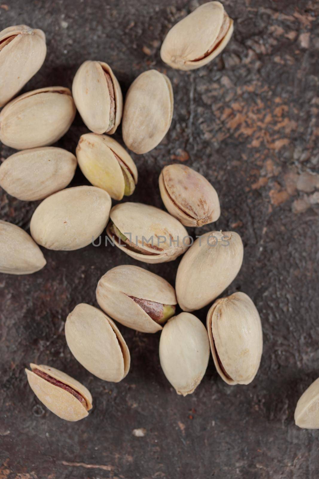 Organic pistachios on a dark background macro