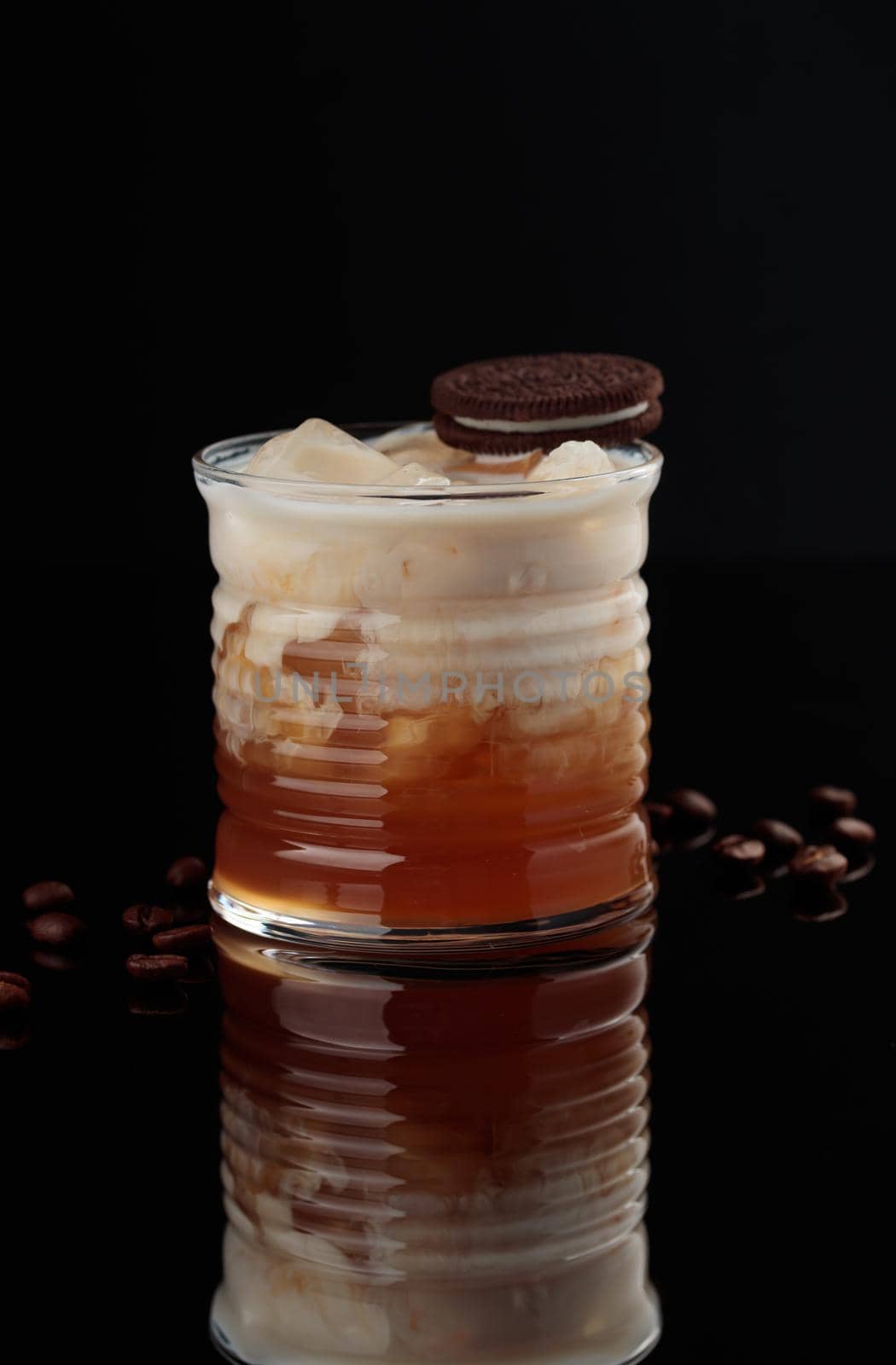 Cocktail in a glass on a black background vertical