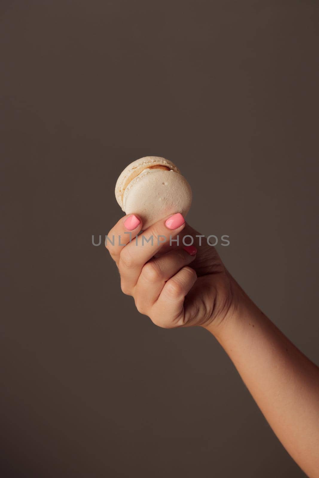 French macaroons in woman's hand