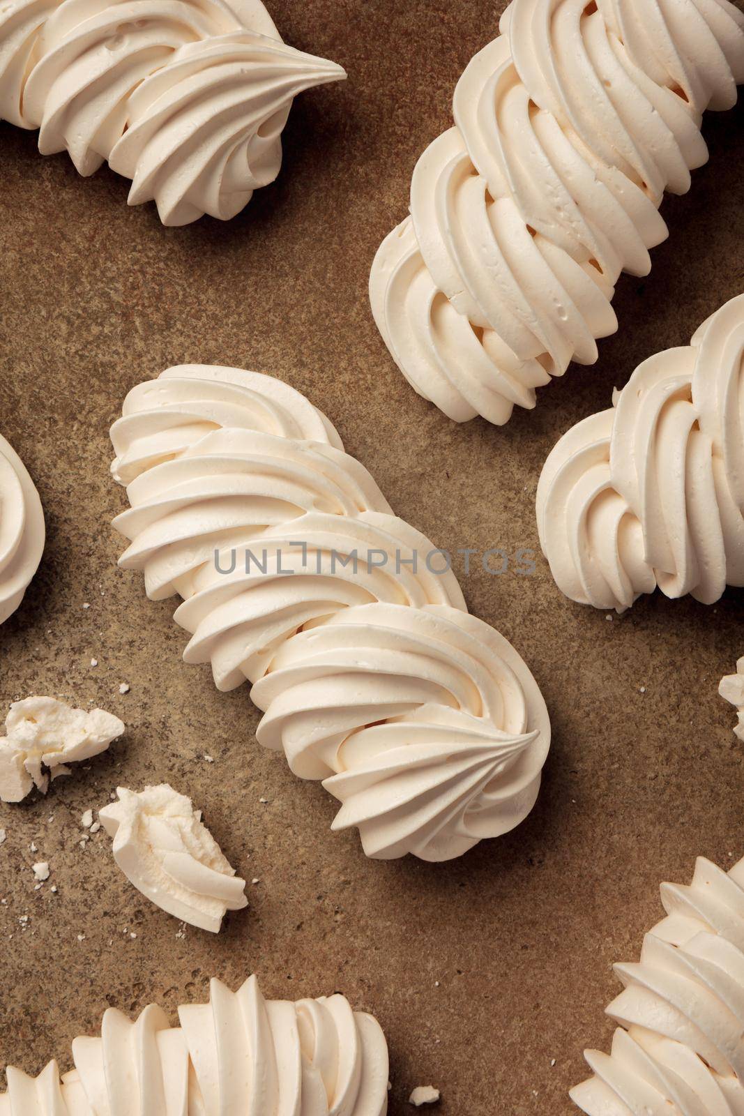Close up sweet meringue on a brown background top view