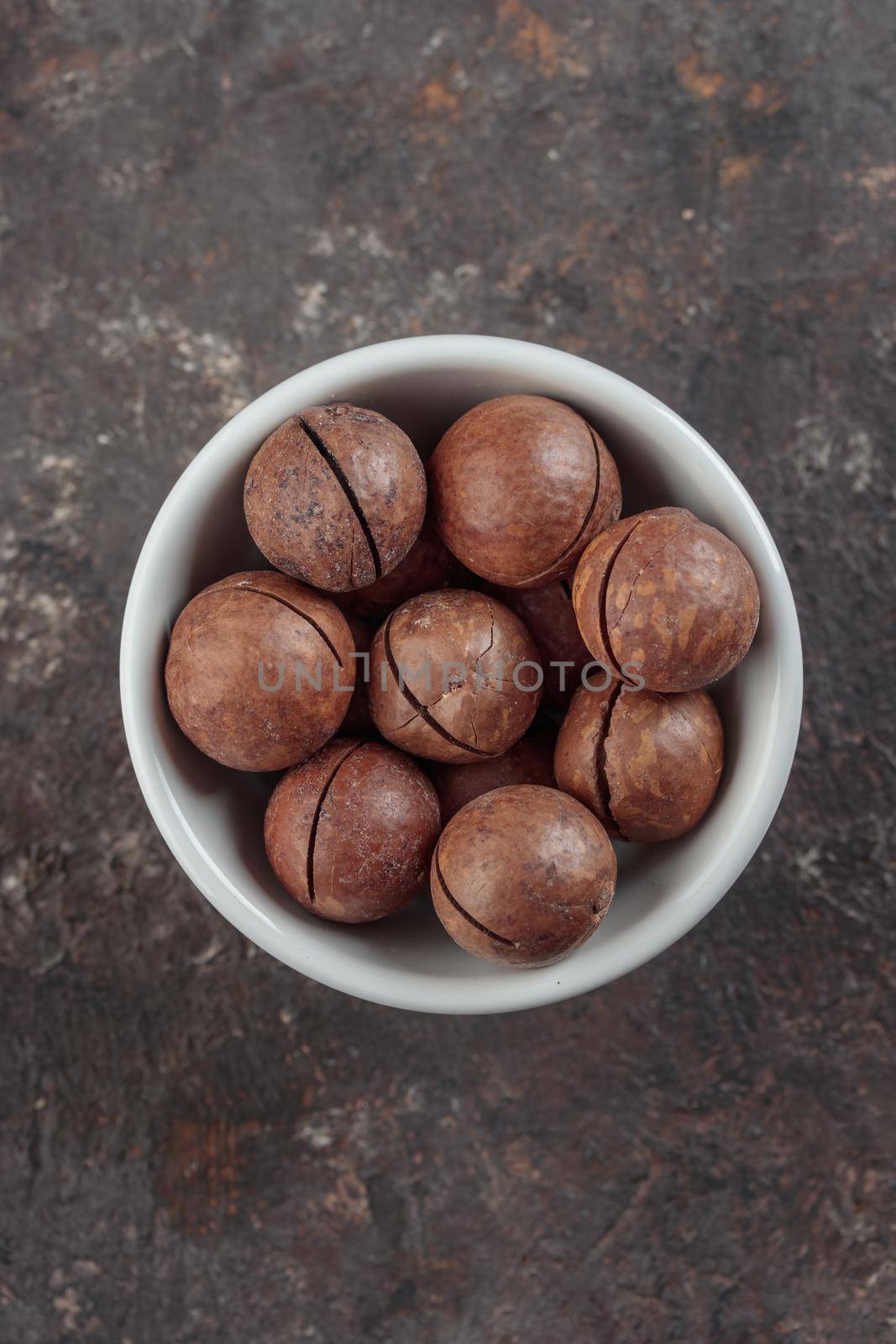 Macadamia nuts on a grey background top view