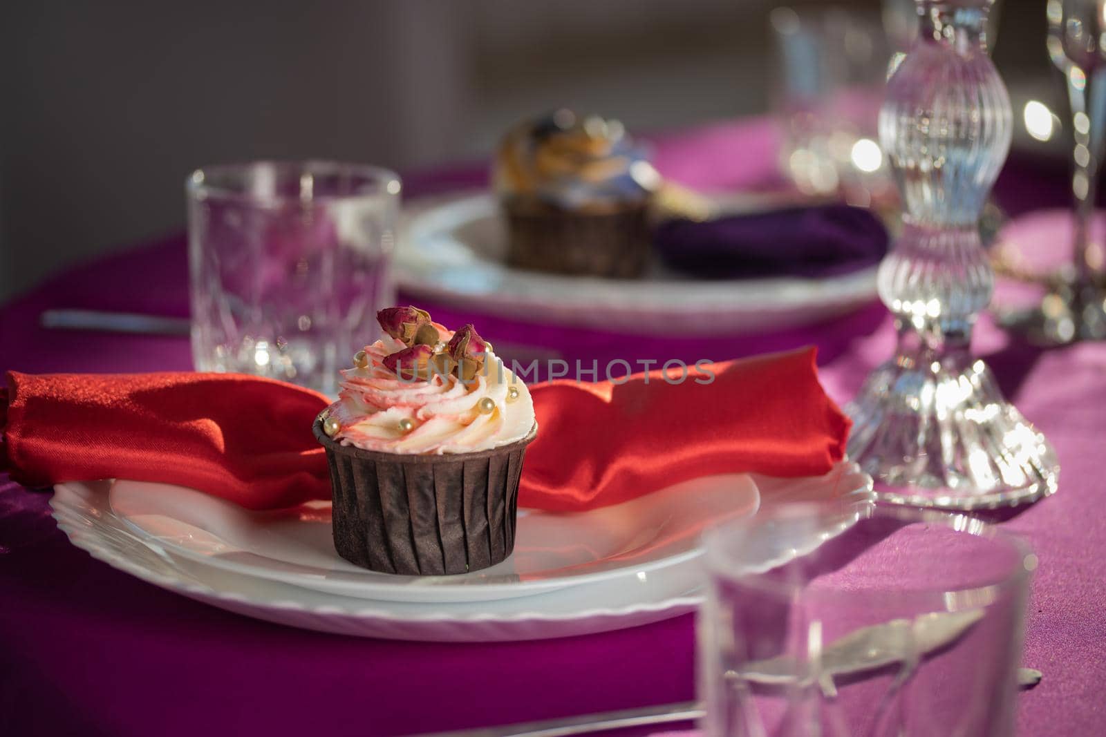 Pink and purple decoration and cupcakes on the table