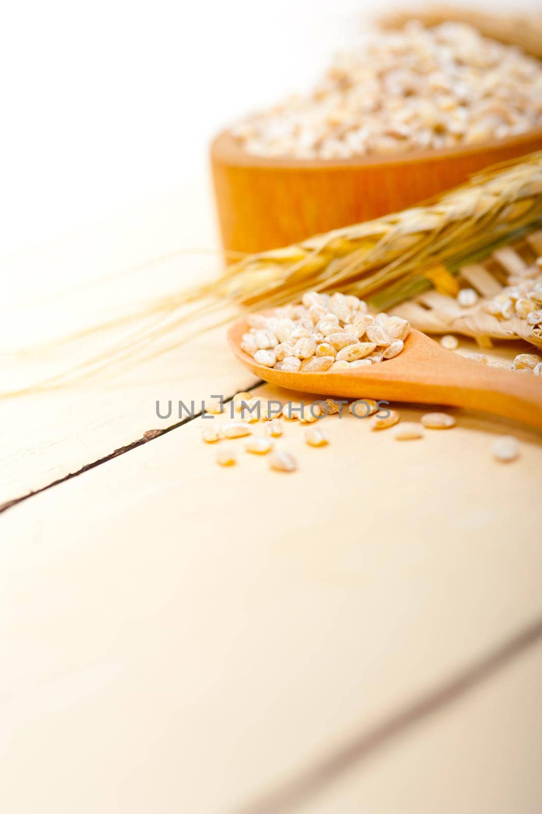 organic barley grains over rustic wood table macro closeup