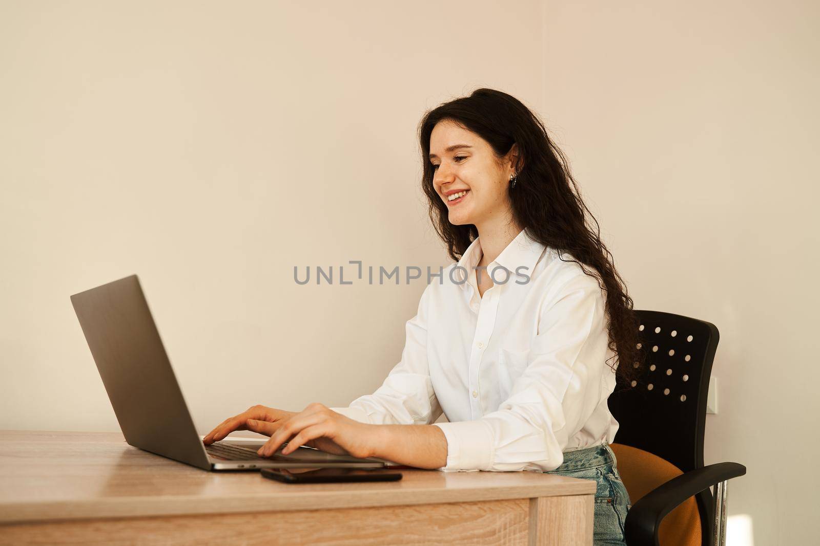 Attractive girl connects online video call with friends. Communication online with laptop. by Rabizo