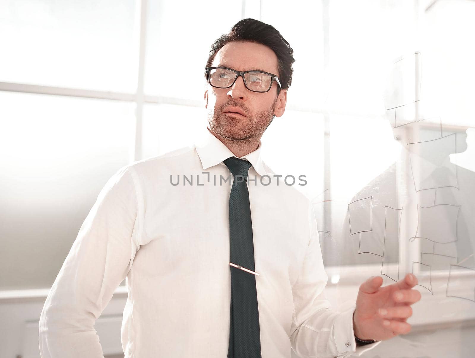 businessman standing near a glass Board.business concept