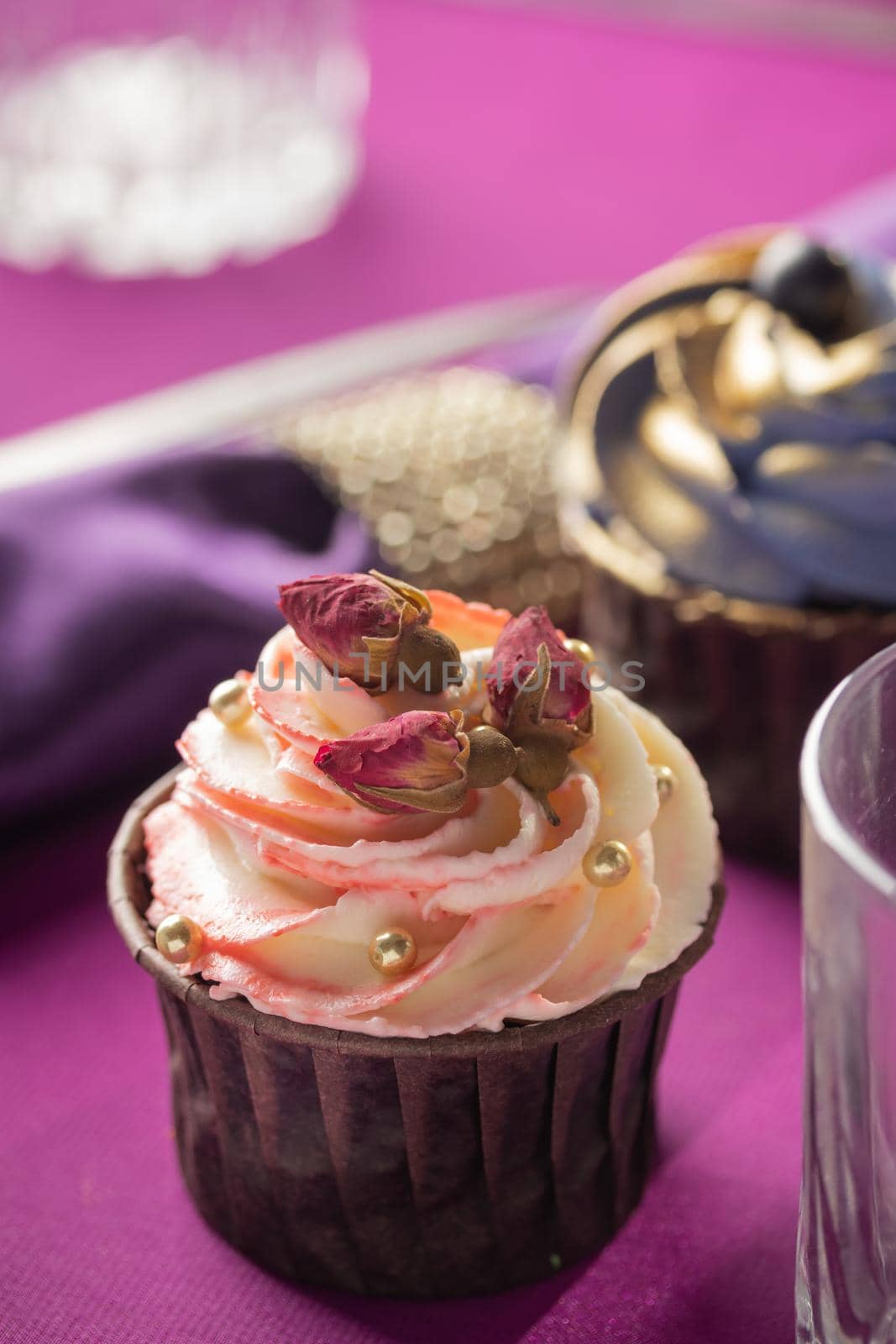 Pink and purple decoration and cupcakes on the table