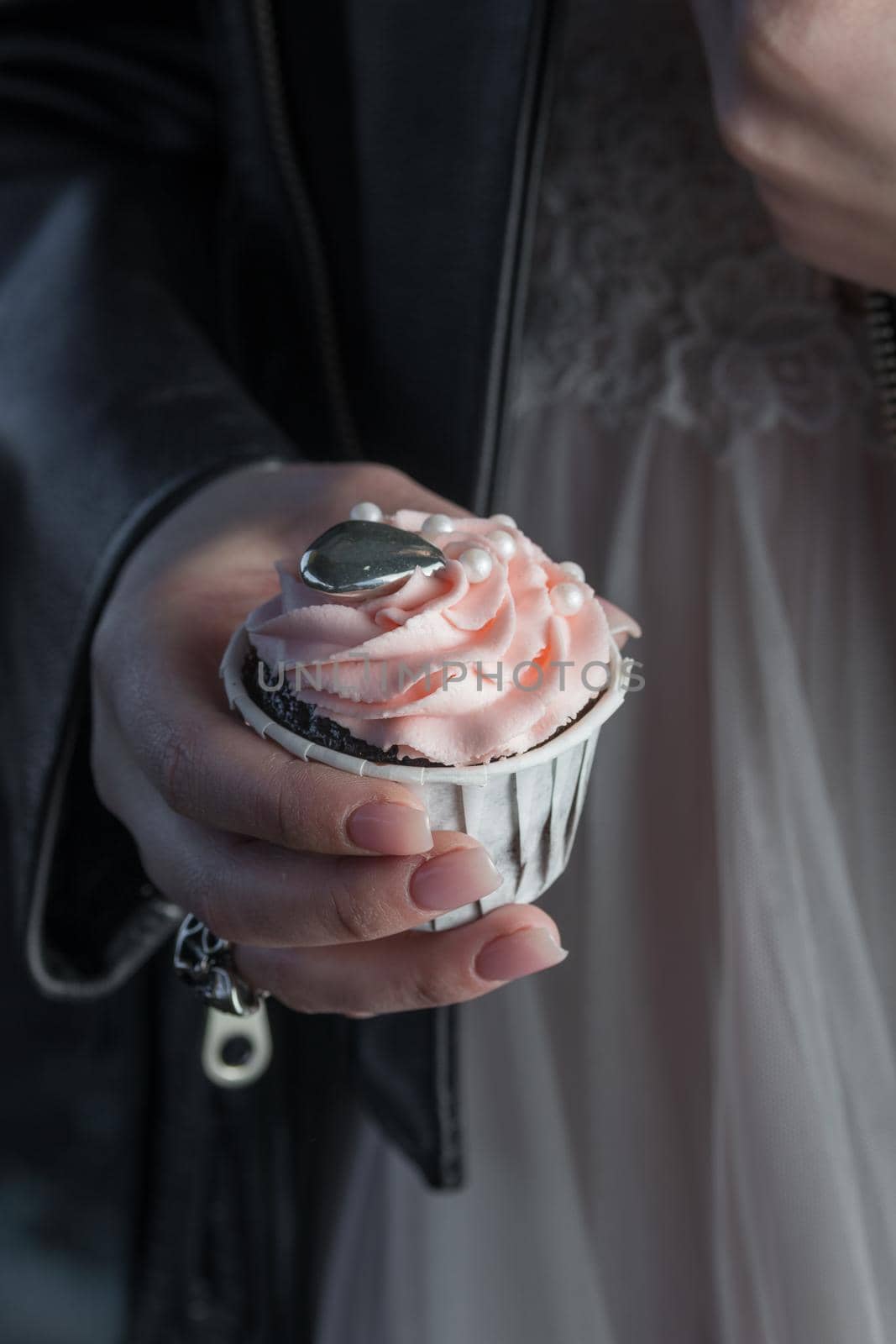 Grunge style cupcakes with black and pink cream vertical