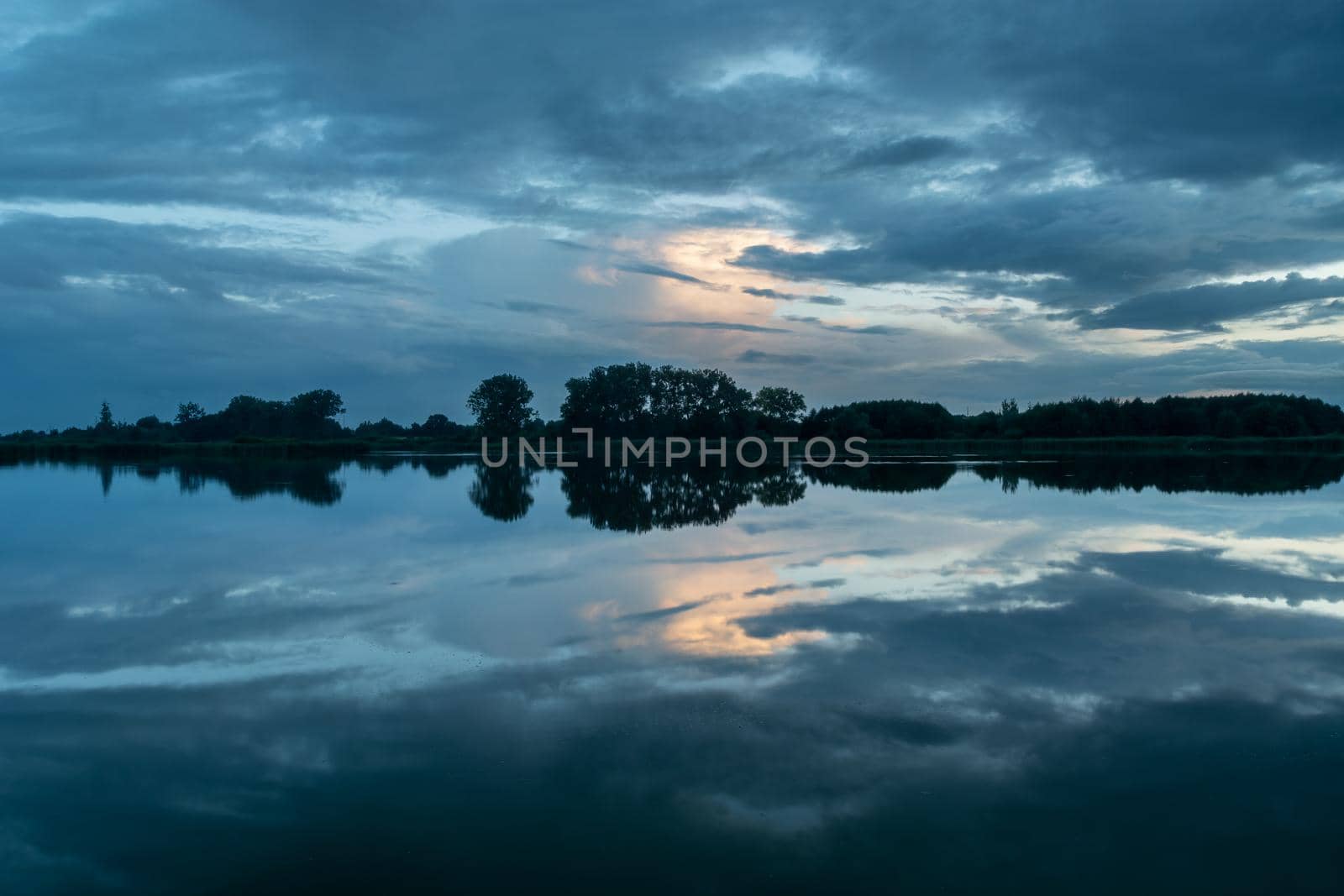 Picturesque clouds reflecting in the water, evening view, Stankow, Poland