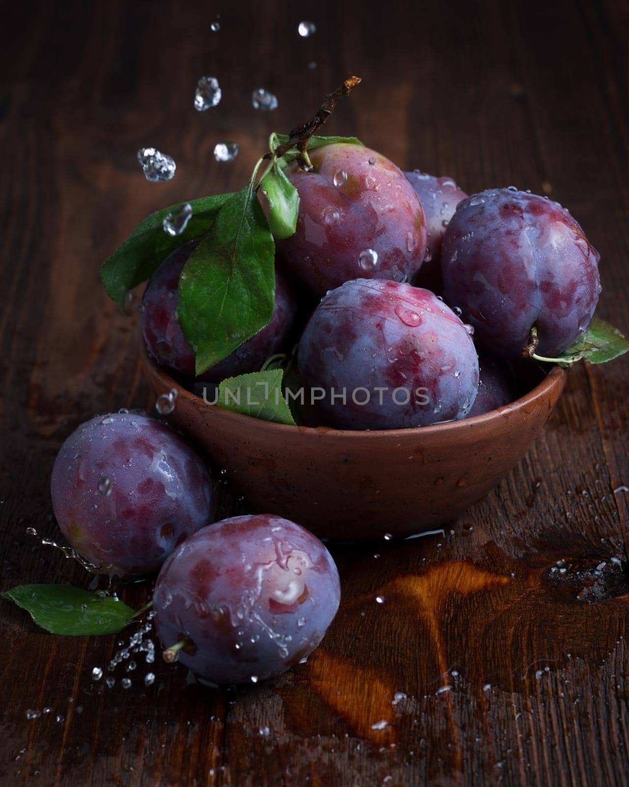 Fresh ripe plums on a dark background