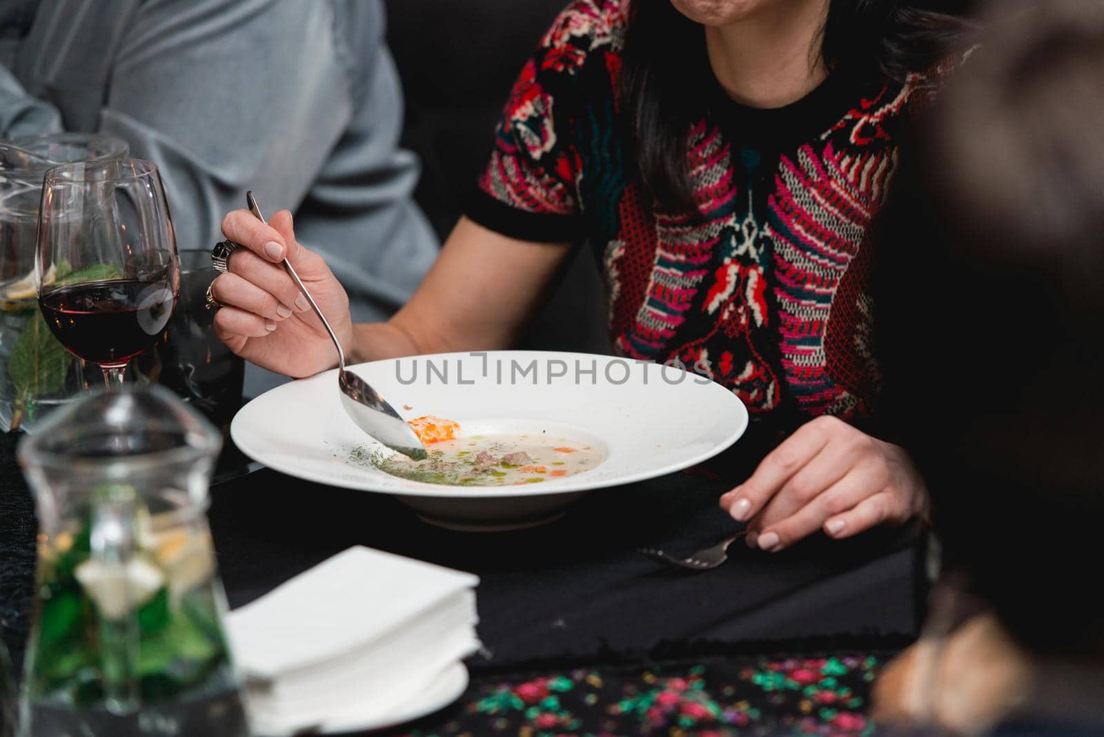 Woman eating mushroom cream soup in a restaurant by Ashtray25