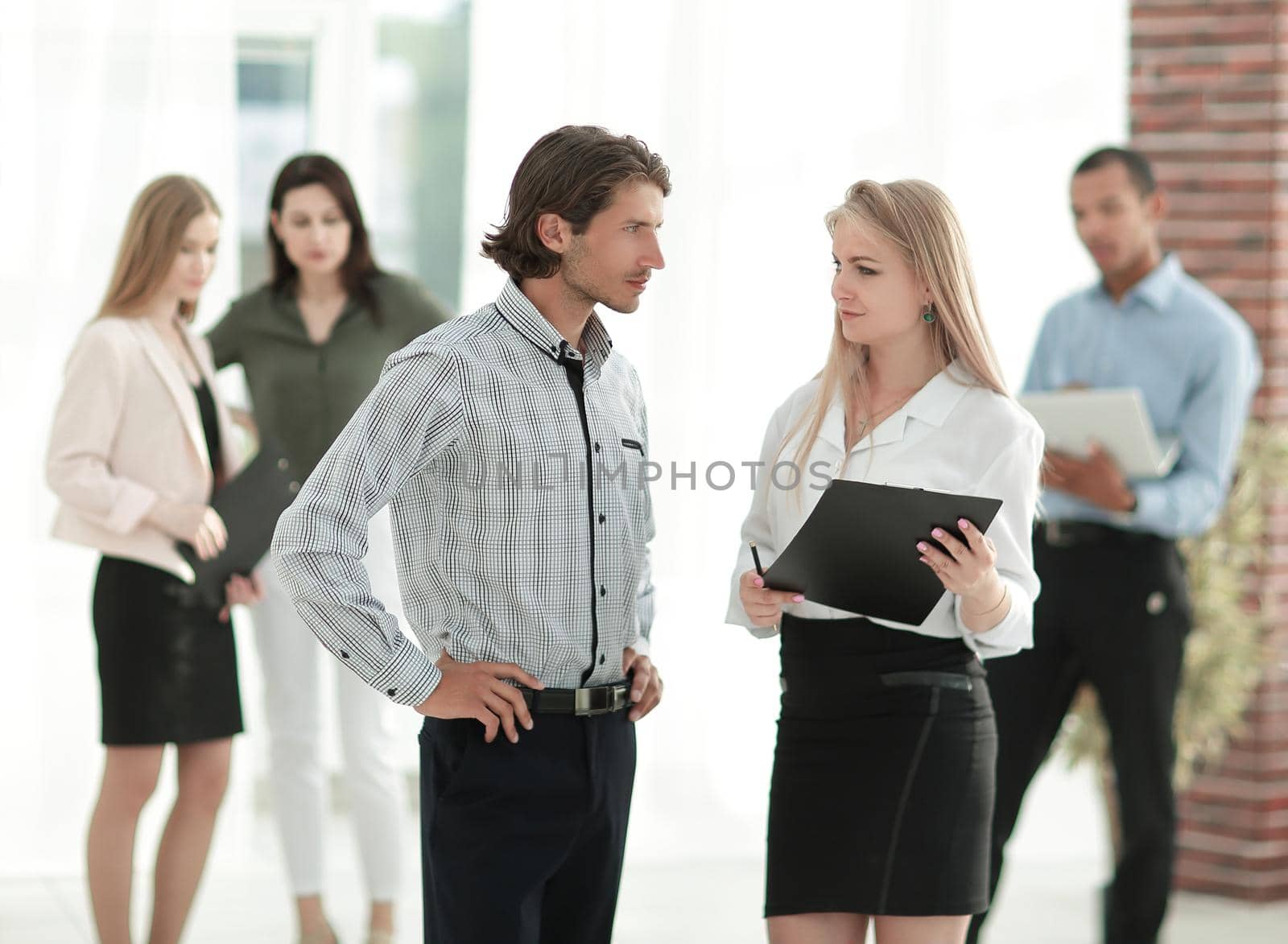 businessman and business woman standing in a modern office. by SmartPhotoLab