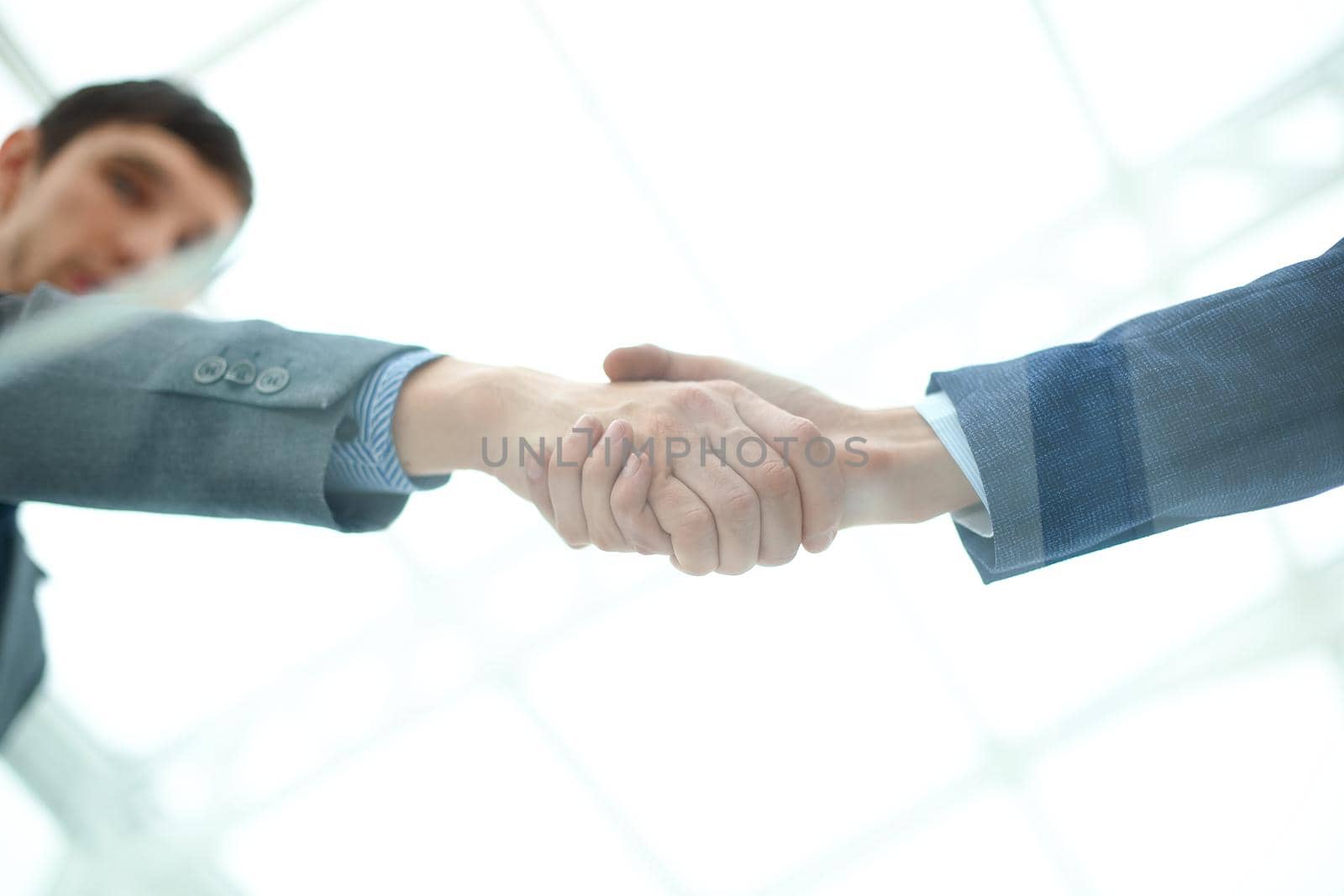 because of glass.handshake of business partners.bottom view by SmartPhotoLab