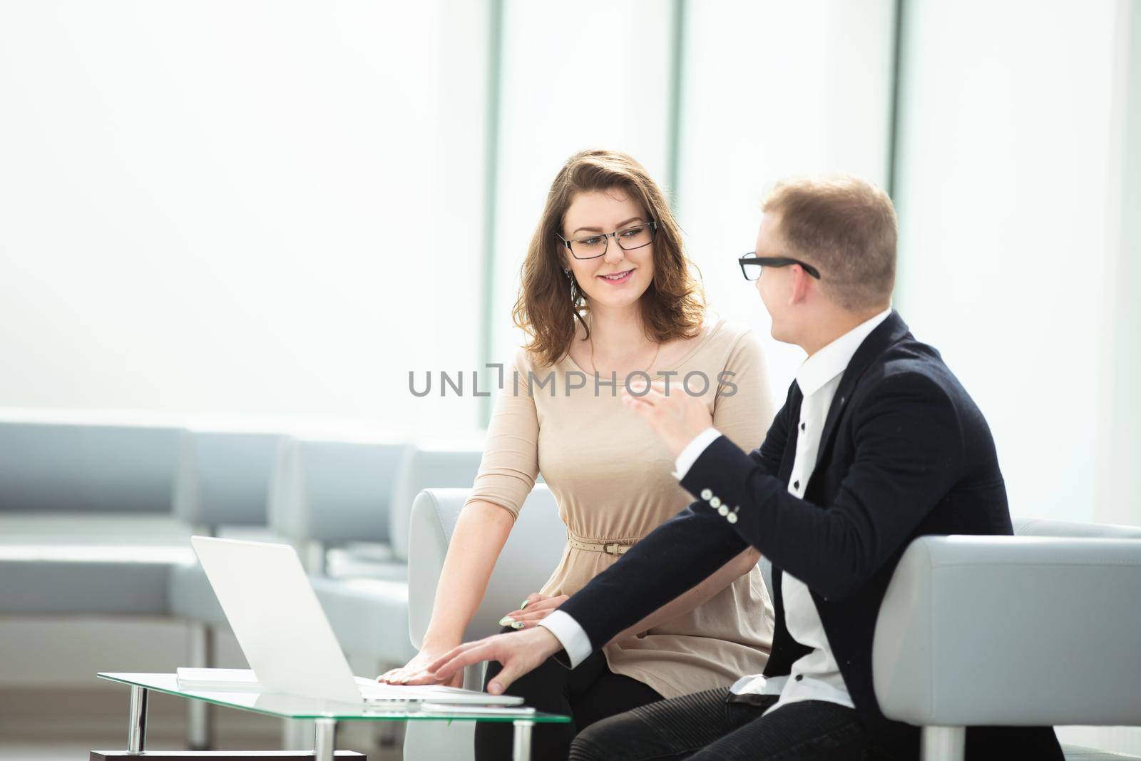businessman and business woman discussing online information by SmartPhotoLab