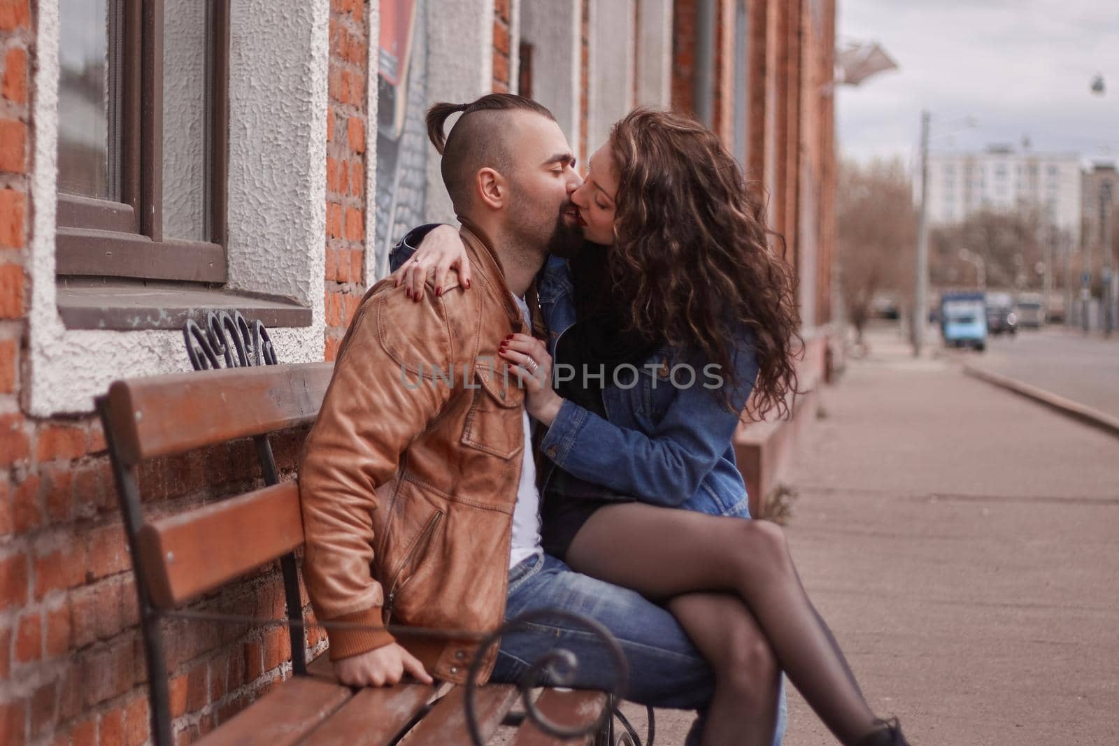 romantic couple in love kissing, sitting on the bench . the concept of love and relationships