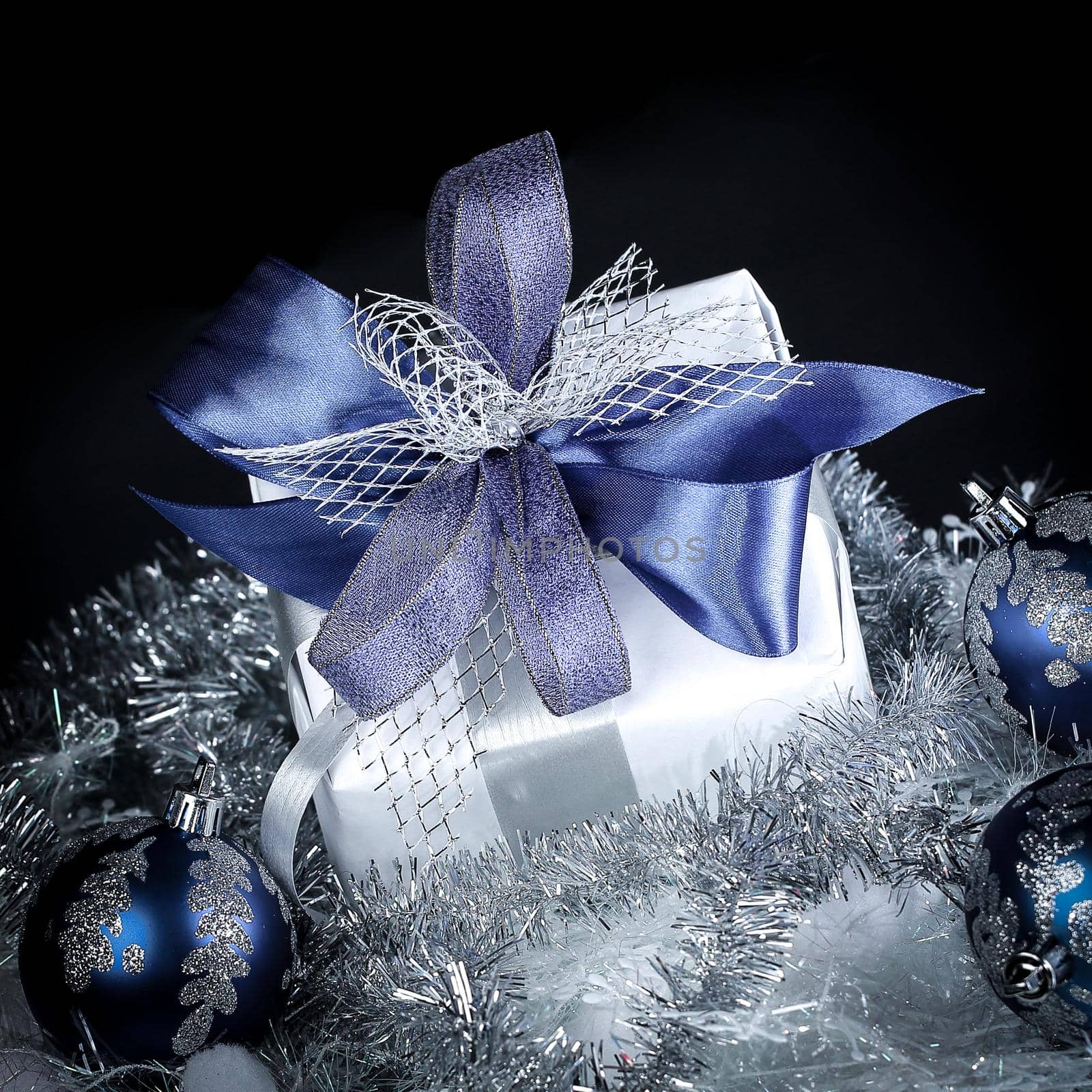 closeup .Christmas gift and blue Christmas balls on a festive w by SmartPhotoLab
