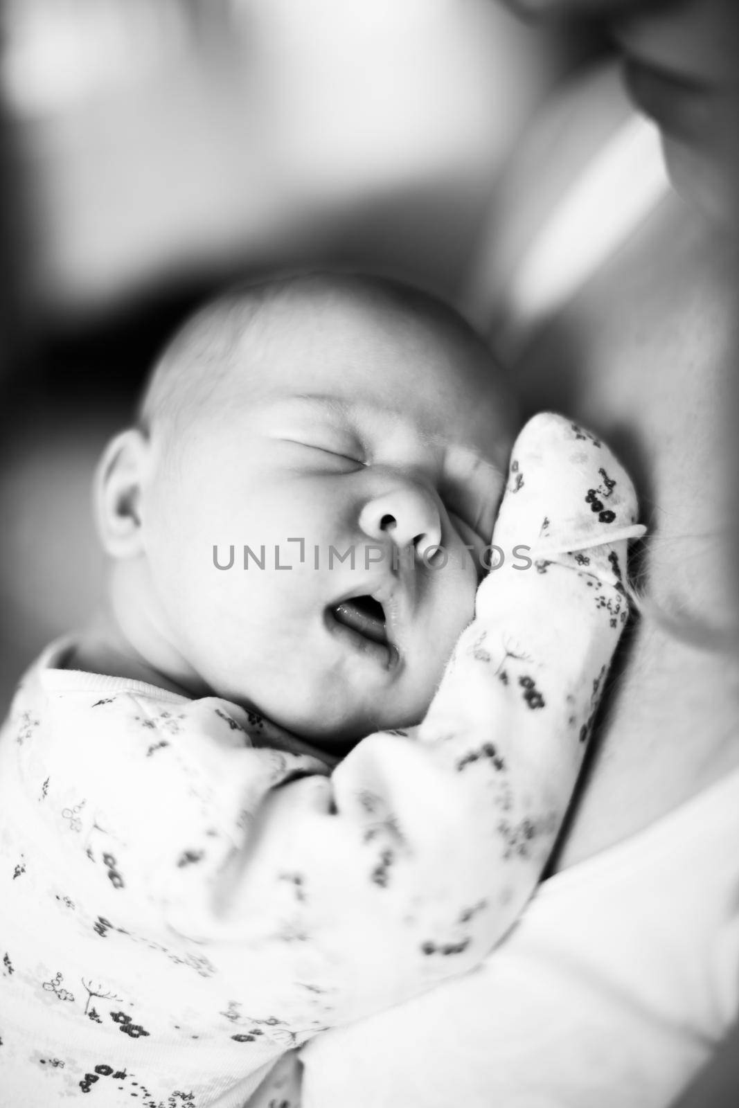 black and white photo in retro style.a pretty sleeping newborn baby . close up.