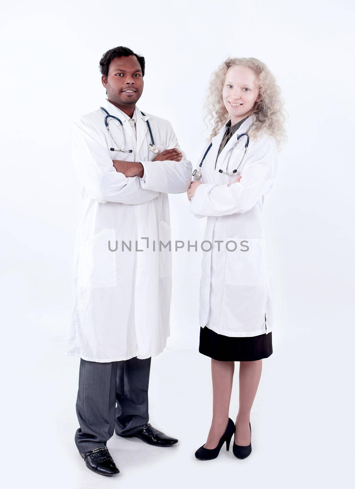 Full body portrait of two happy smiling young medical people, isolated over white background