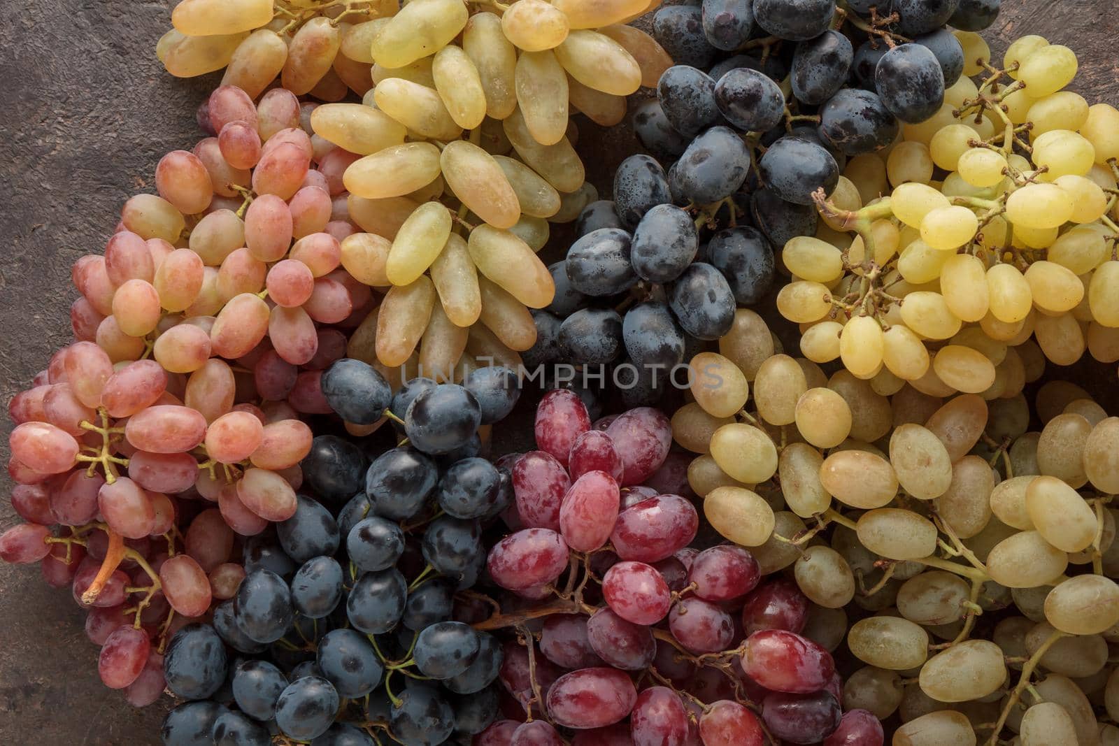 Grapes in a wooden box on a dark background