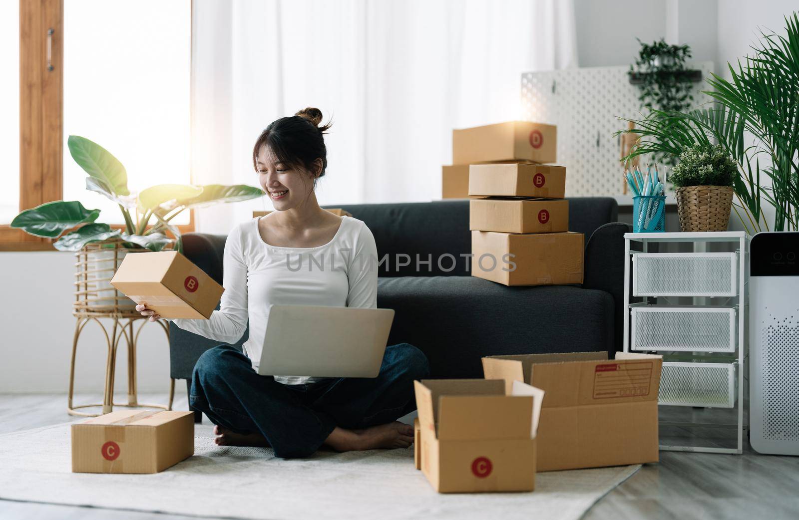 Portrait of Starting small businesses SME owners female entrepreneurs working on receipt box and check online orders to prepare to pack the boxes, sell to customers, SME business ideas online.