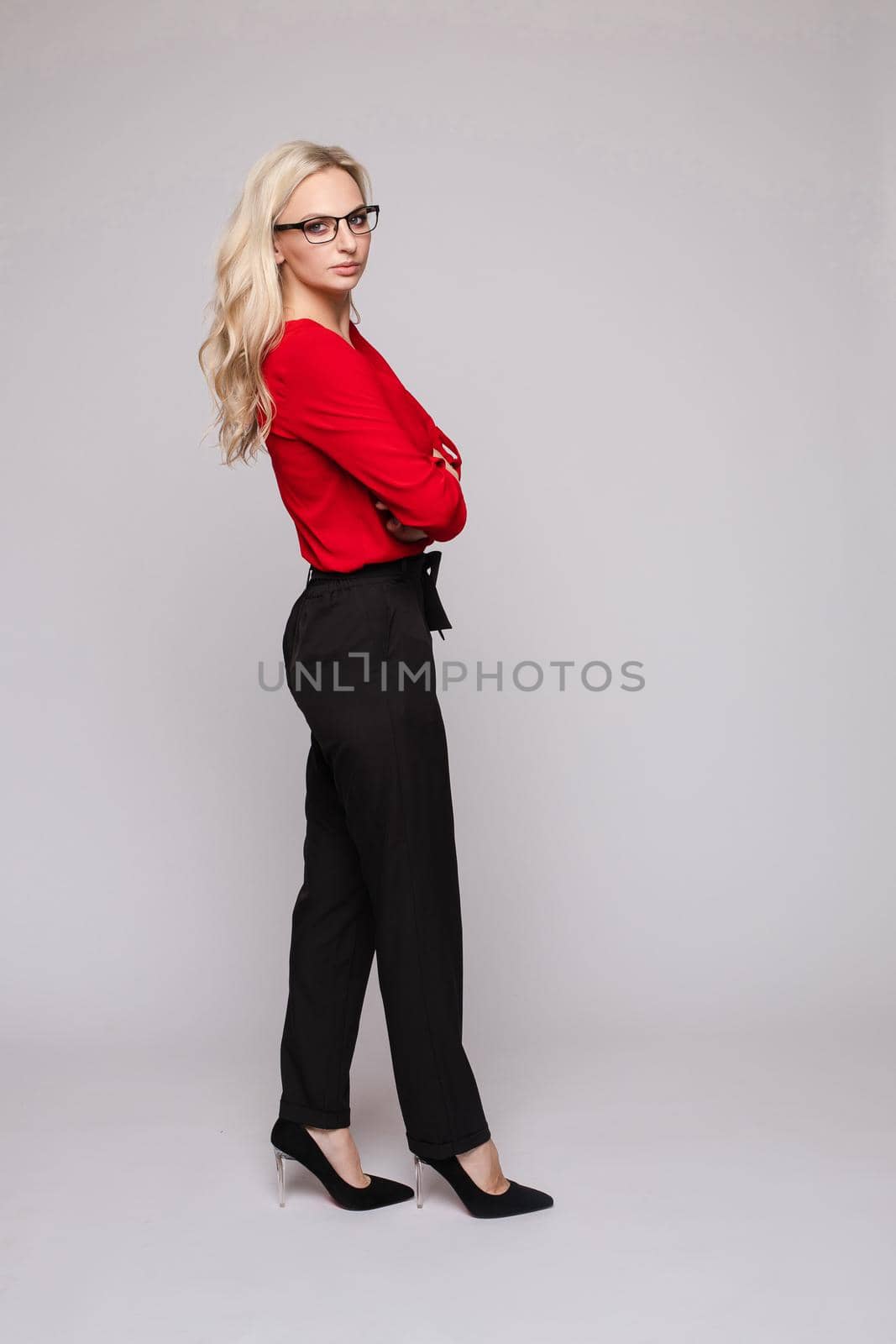 Successful female in smart outfit and glasses posing by StudioLucky