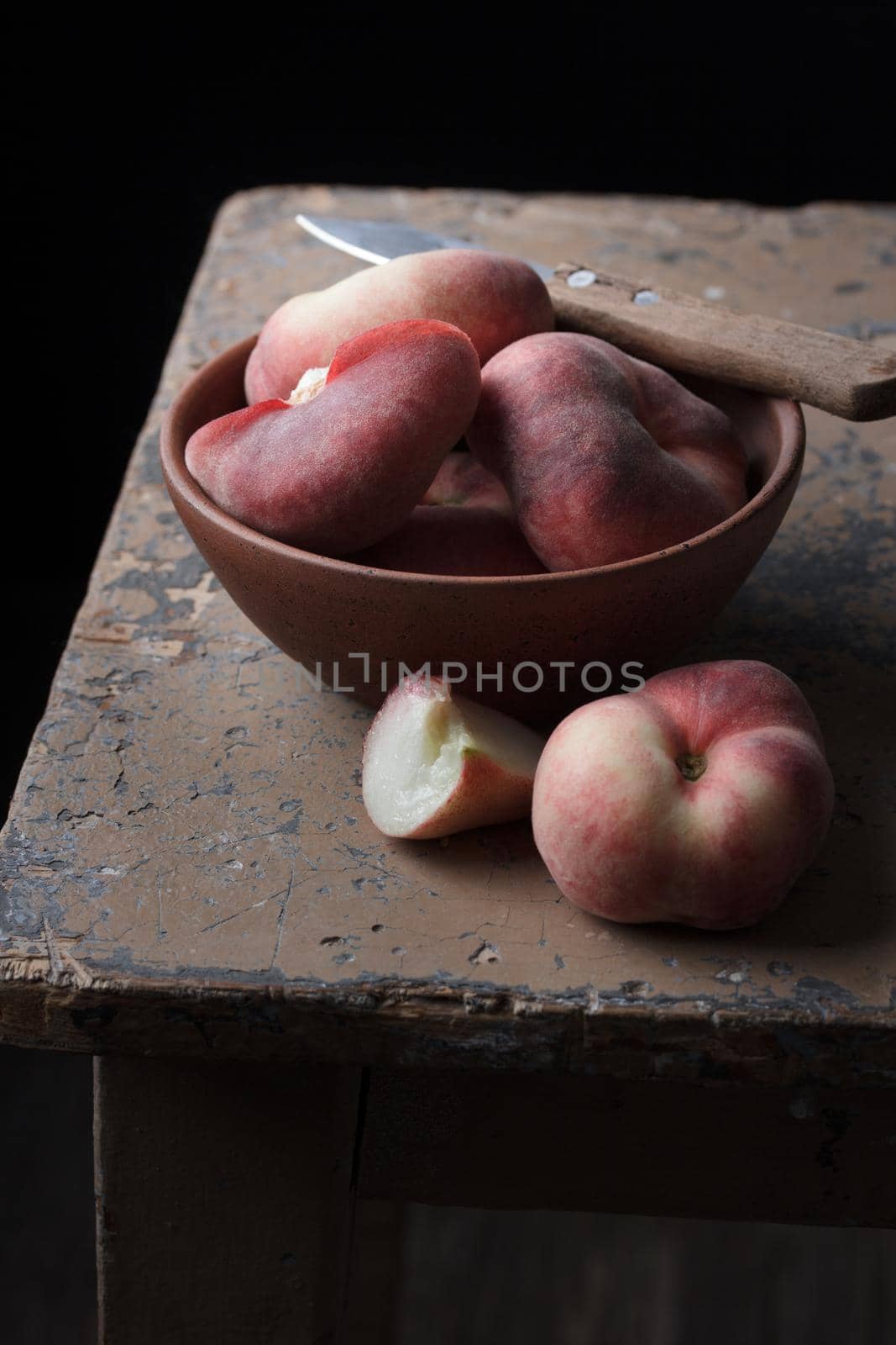 Peaches on an old rustic table Vertical