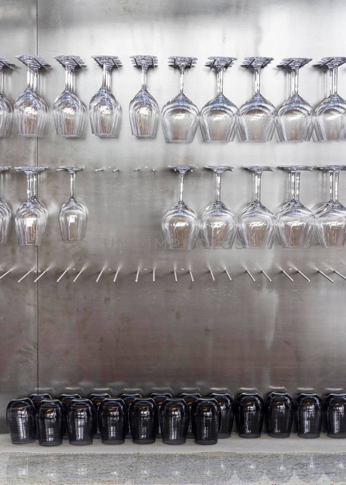 Wine glasses hanging on wall in wine shop