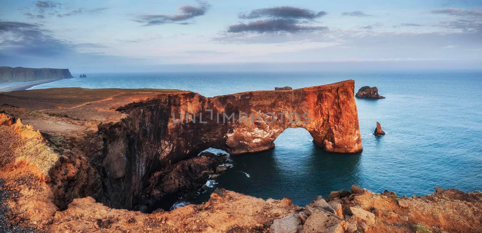 Cape Dyrholaey at southern Iceland. Altitude 120 m, and mean hill island with a door opening.