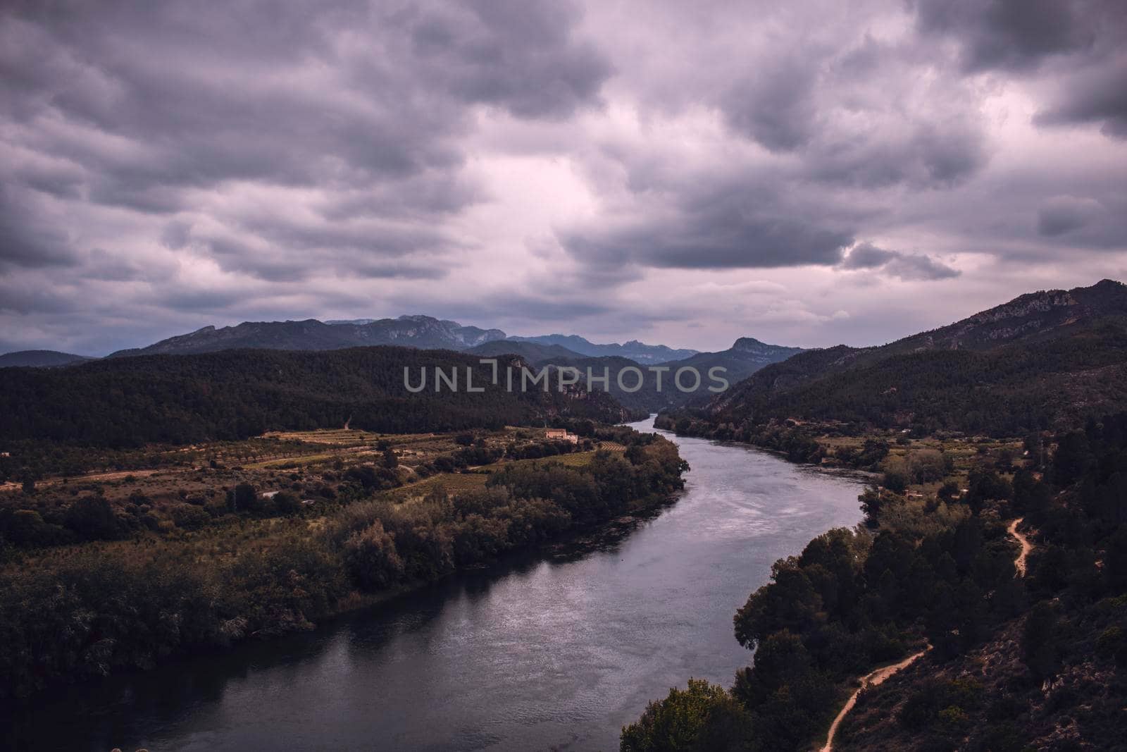 Curved river under a cloudy sky by ValentimePix