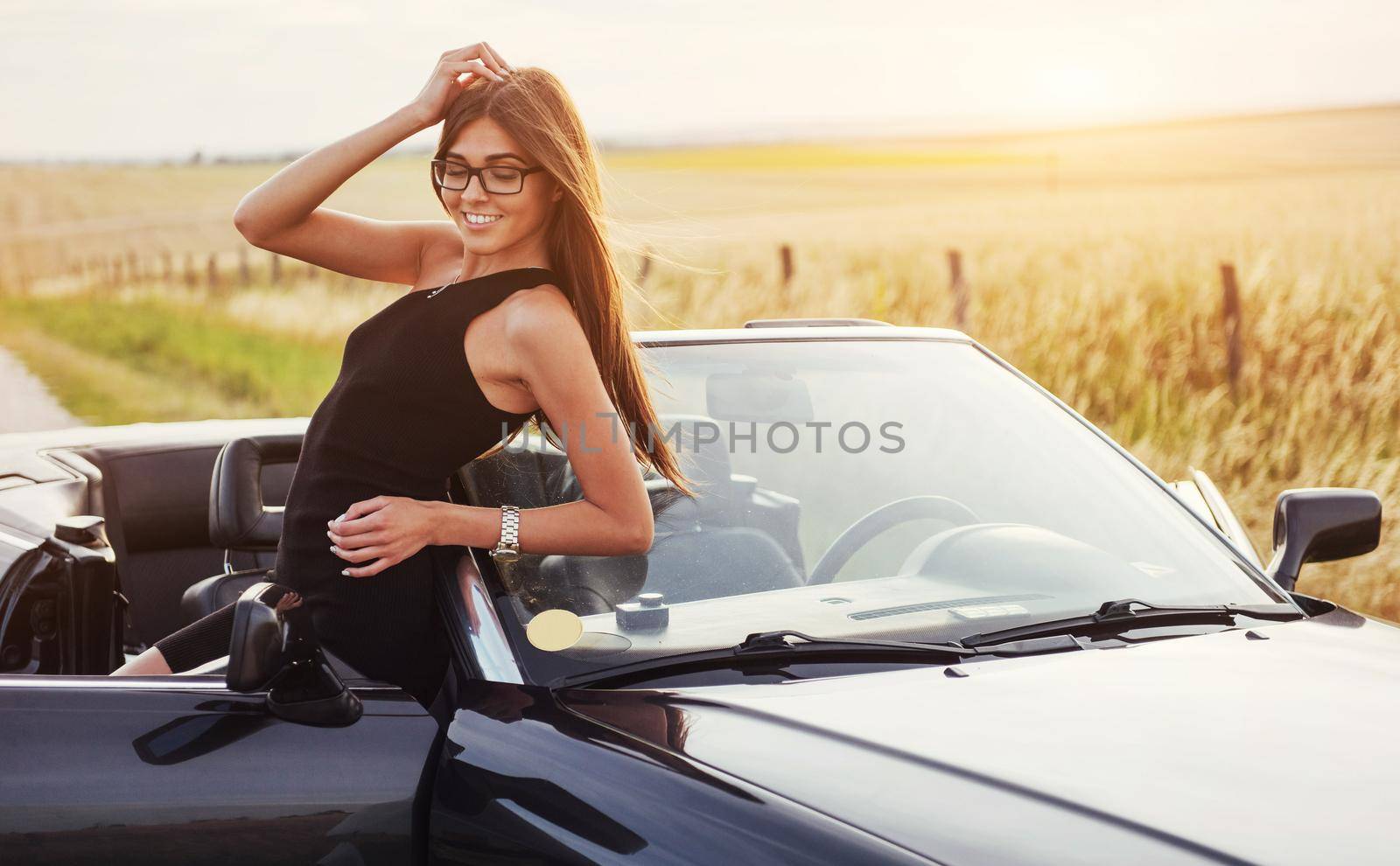 Beautiful woman near black convertible. Ukraine. Europe
