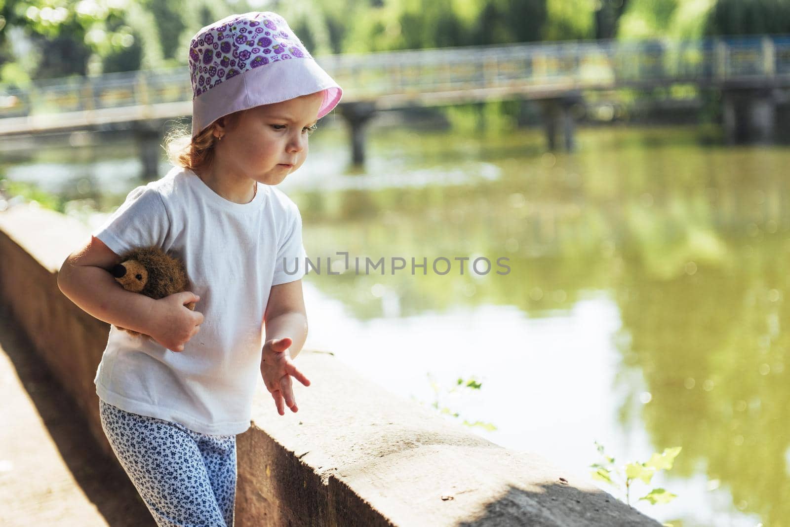 beautiful summer day and happy girl near the water